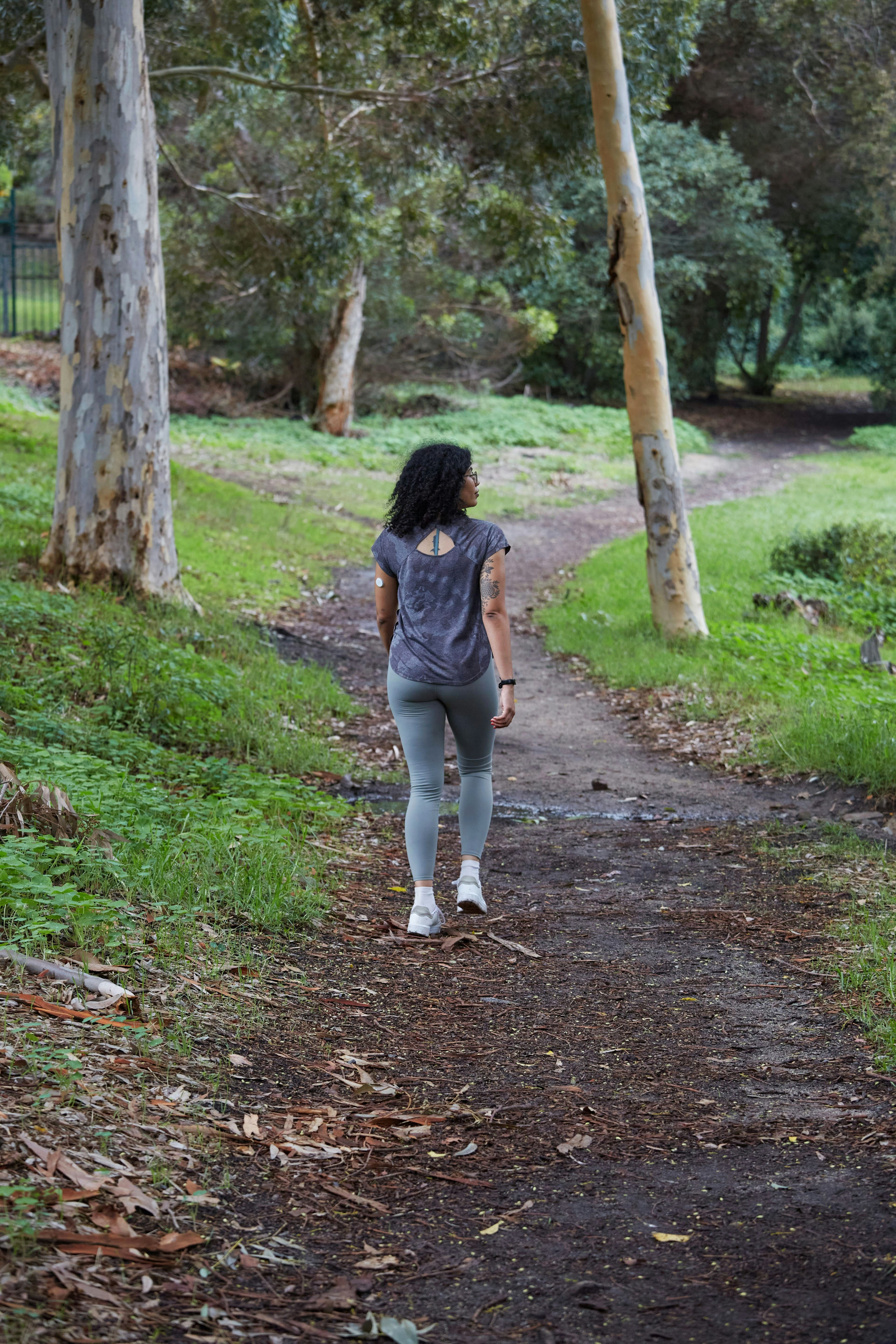 Woman walking on a peaceful forest path